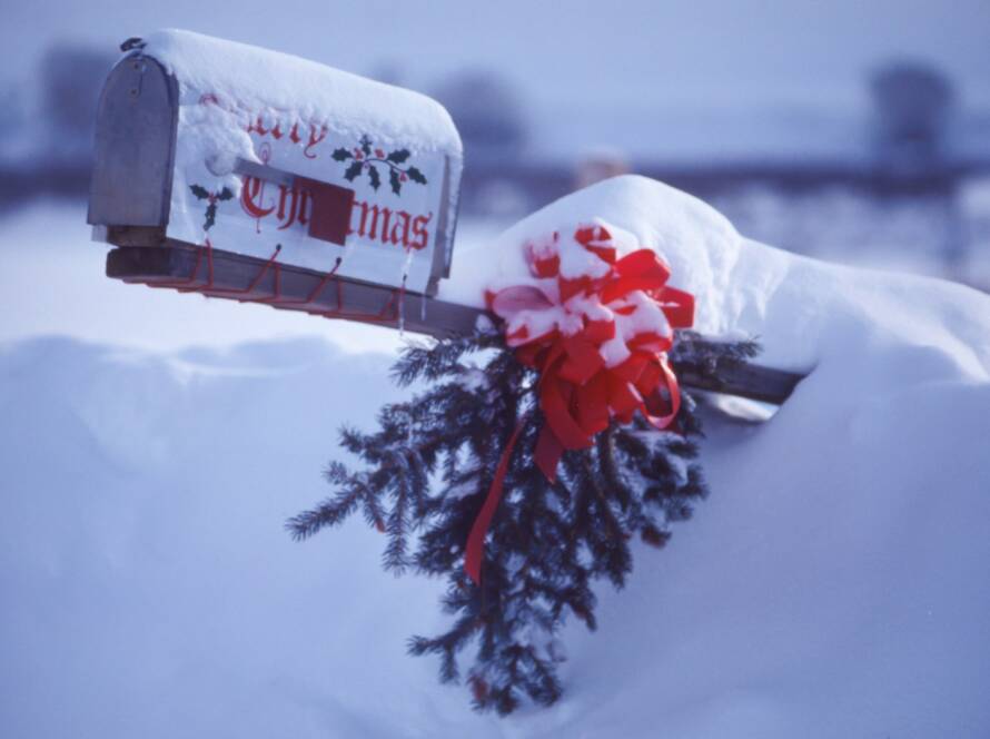 white and red mailbox covering snow